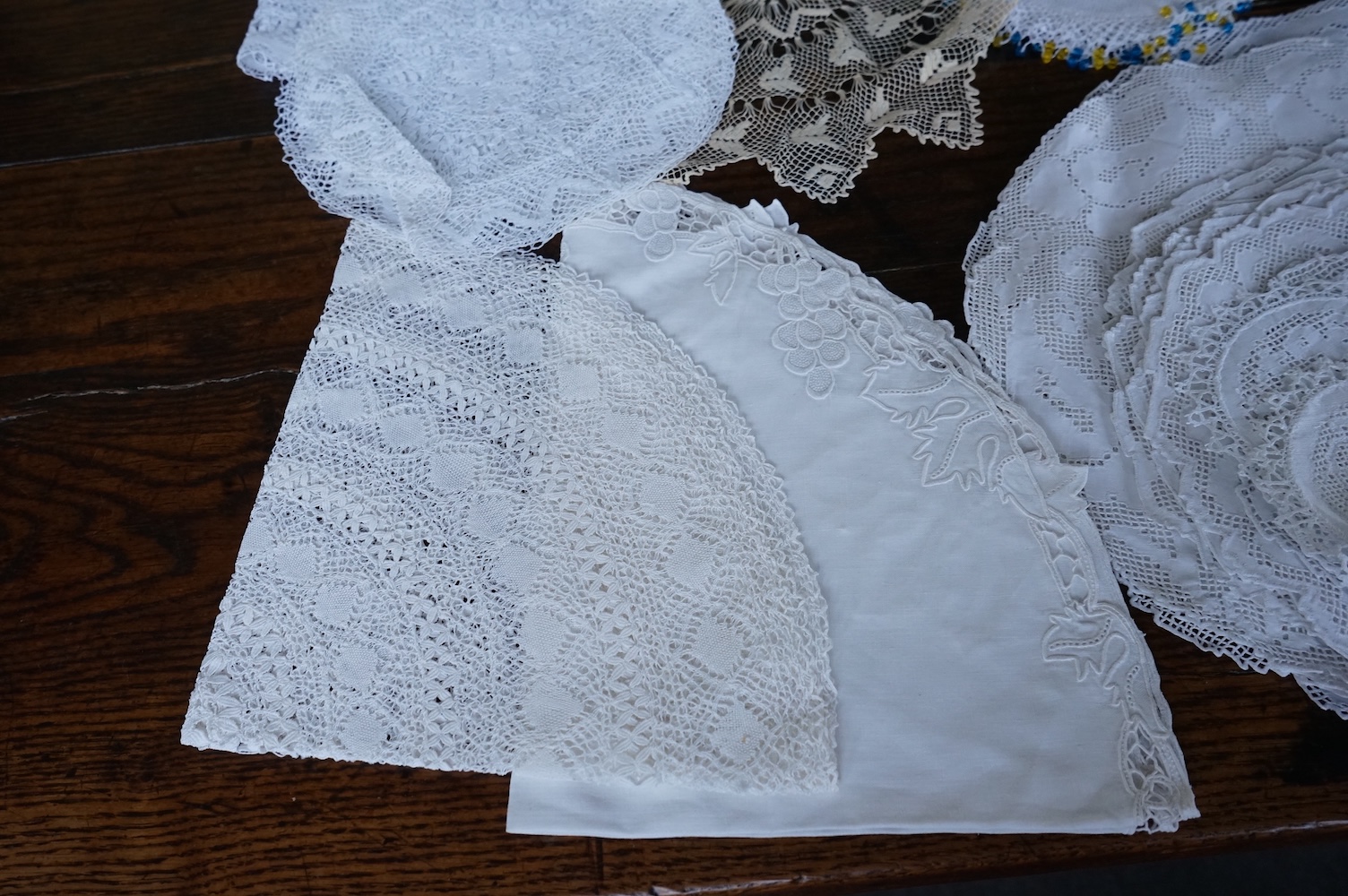 A 19th century large linen cut work collar, together with various sets of circular cut work mats, a tasselled pelmet and a collection of bobbin lace and tatting worked mats etc., Condition - mostly good